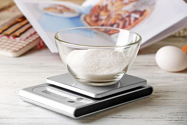 bowl of sugar and digital kitchen scales