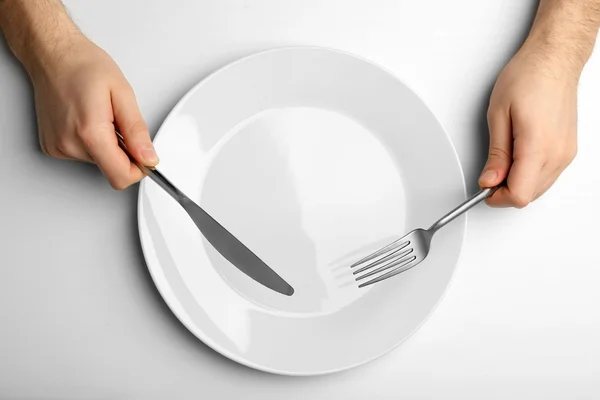 Male hands holding white plate — Stock Photo, Image