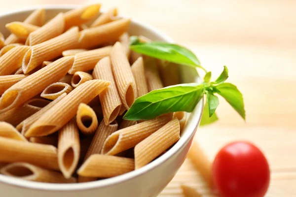 Dry brown penne pasta — Stock Photo, Image
