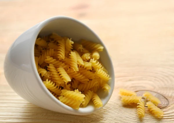 Dry fusilli pasta in white bowl — Stock Photo, Image