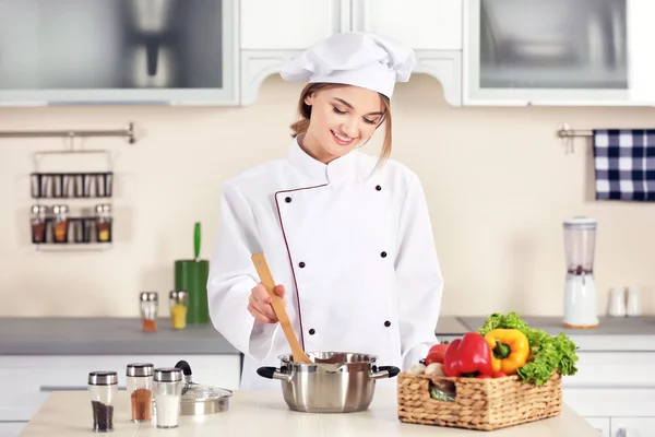 Young woman cooking in kitchen — Stock Photo, Image