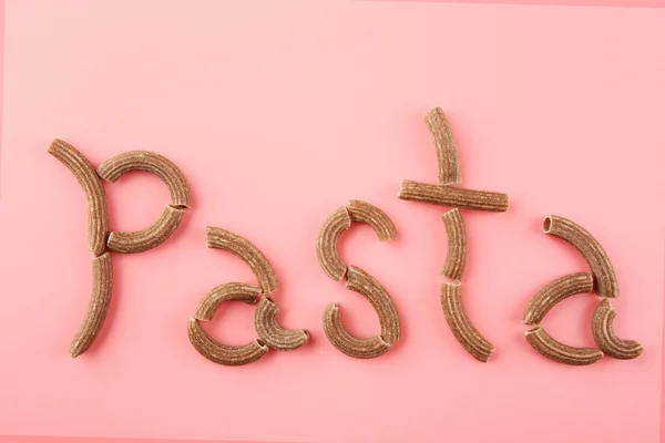 Pasta word made with brown macaroni — Stock Photo, Image