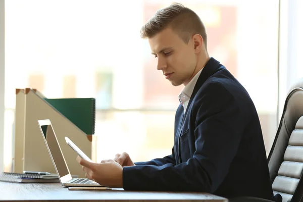 Człowiek za pomocą laptopa przy stole w biurze — Zdjęcie stockowe