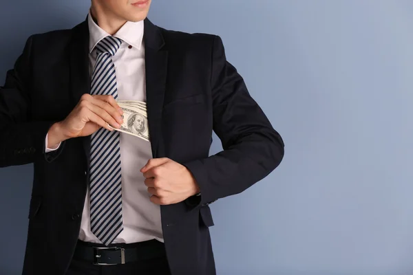 Man hiding dollar banknotes — Stock Photo, Image