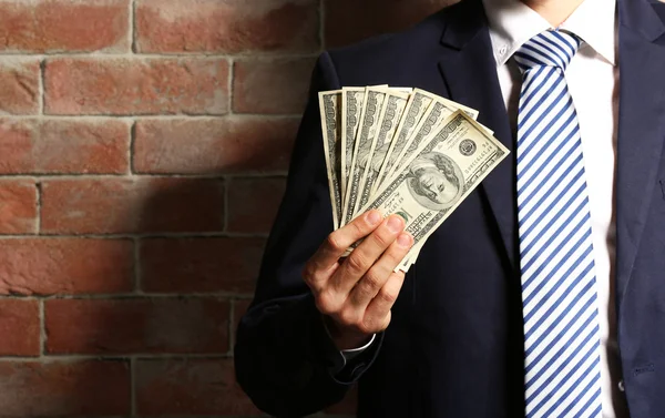 Man holding fan of banknotes — Stock Photo, Image