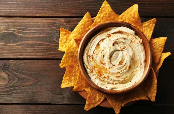 Wooden bowl of tasty hummus — Stock Photo, Image