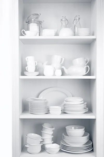 Dishes in cupboard in the kitchen — Stock Photo, Image