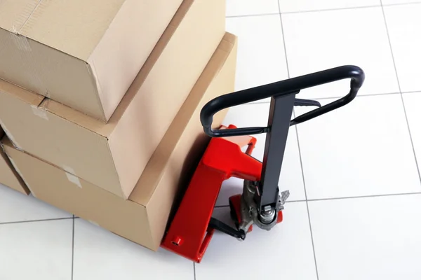 Manual pallet truck with carton boxes — Stock Photo, Image