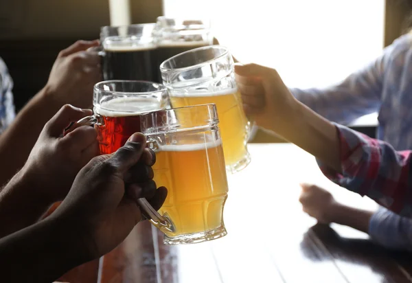 Friends drinking beer in pub