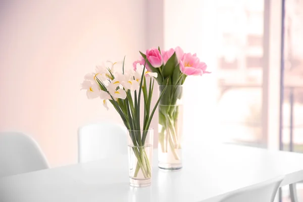 Tulips and irises on dinning table — Stock Photo, Image