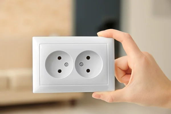 Hand holding power outlet — Stock Photo, Image