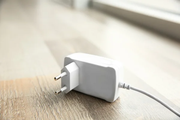 Power plug on  floor — Stock Photo, Image