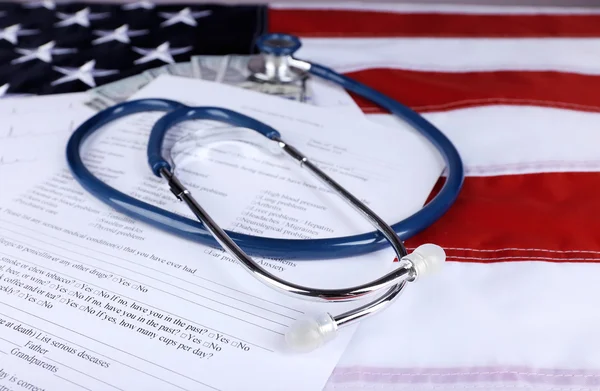 Stethoscope with medical form and dollar banknotes — Stock Photo, Image