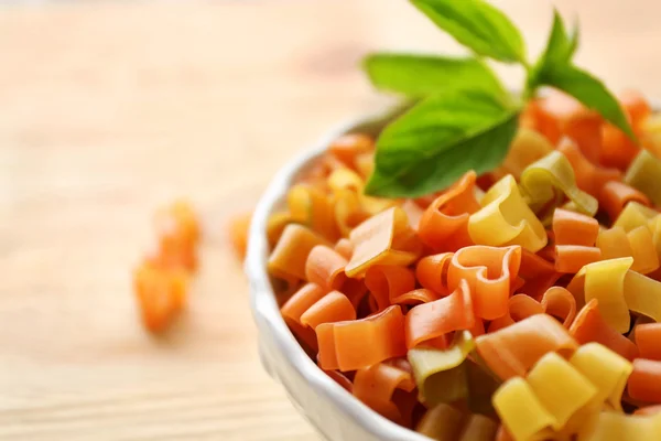 Torr mångfärgade hjärtformade pasta i vit skål, närbild — Stockfoto