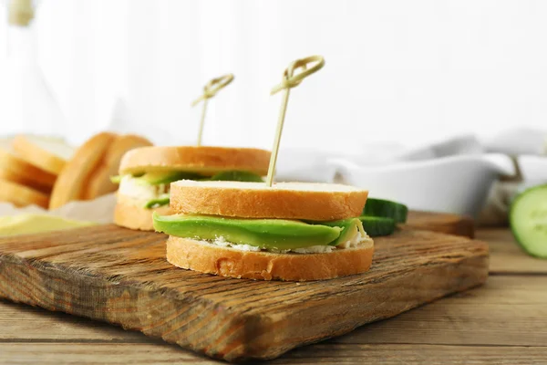 Sandwiches de aguacate vegetariano en una tabla de madera —  Fotos de Stock