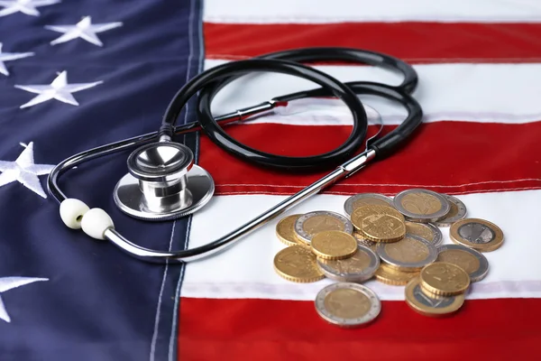 Stethoscope and metal coins — Stock Photo, Image