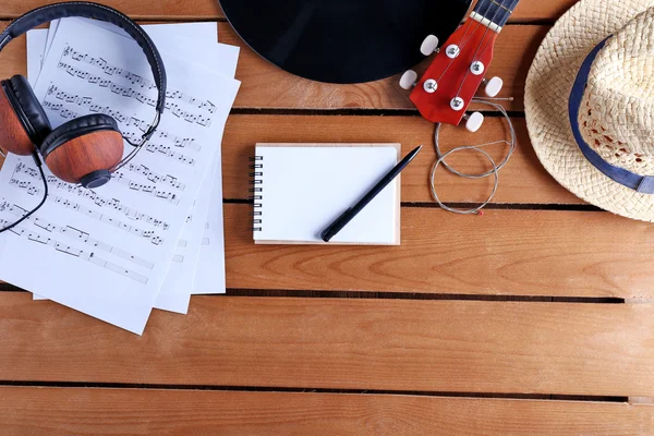 Guitar, headphones and music sheets — Stock Photo, Image