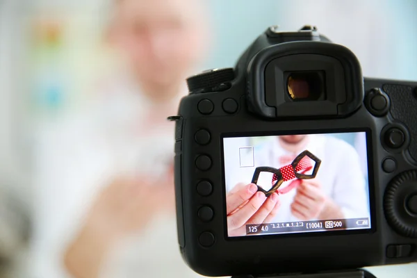 male blogger with on camera screen