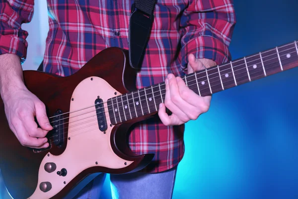 Man plays electric guitar