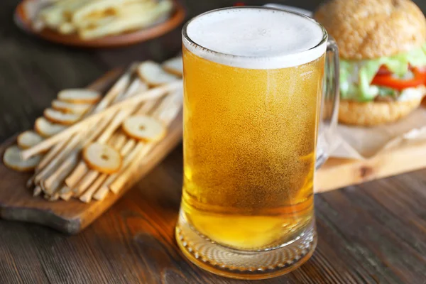 Glass mug of light beer with snacks — Stock Photo, Image