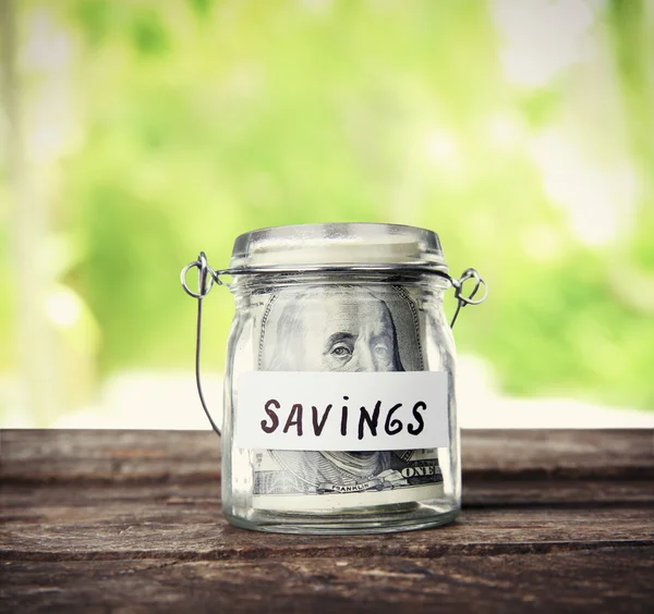 Jar for savings full of banknotes — Stock Photo, Image