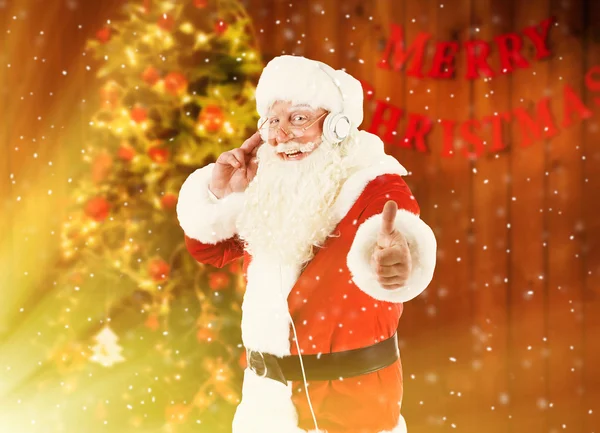 Santa claus met koptelefoon — Stockfoto