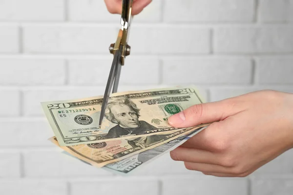 Scissors cutting money — Stock Photo, Image