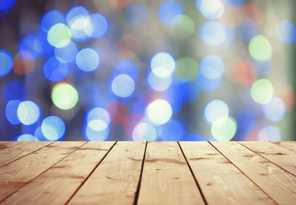 Wooden surface against bokeh background — Stock Photo, Image