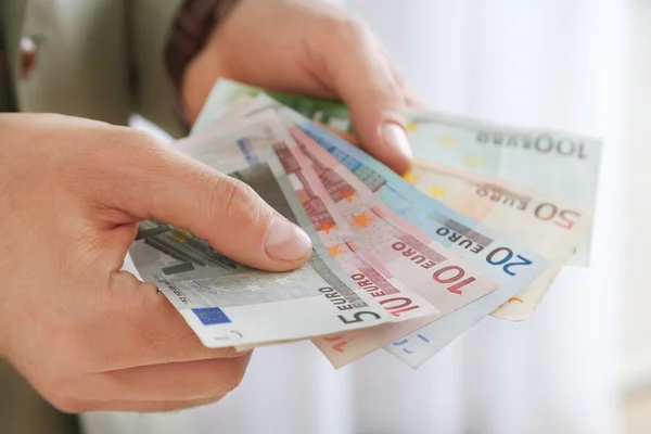 Male hands holding euros — Stock Photo, Image