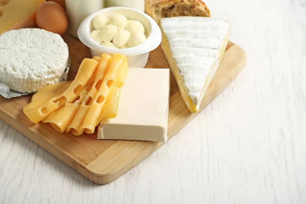Set of fresh dairy products on white wooden table — Stock Photo, Image