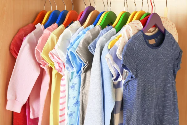 Kid's clothes on hangers — Stock Photo, Image