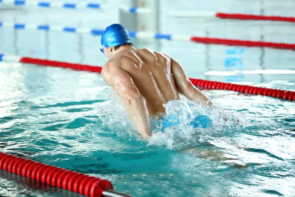 Sporty young man swimming