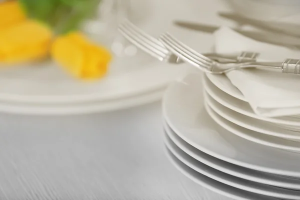 Set of dishes with yellow tulips — Stock Photo, Image