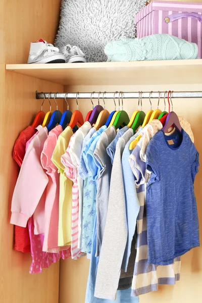 Kid's clothes on hangers — Stock Photo, Image