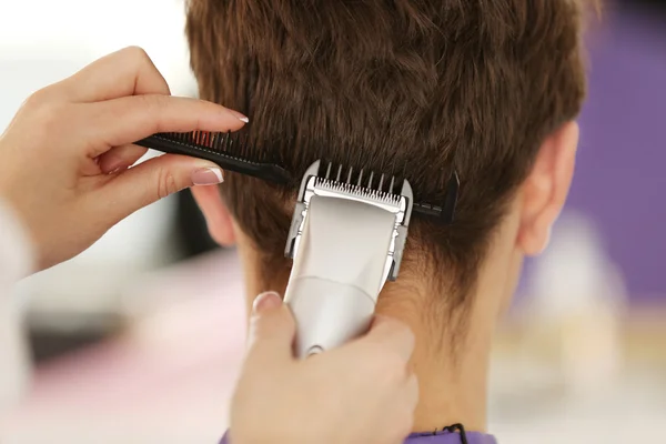 hairdresser making stylish haircut