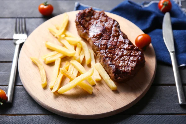 Grilled steak with french fries and cherry tomatoes, closeup — Stock Photo, Image