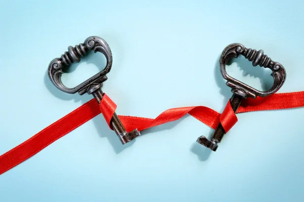 Vintage key with a red ribbon — Stock Photo, Image
