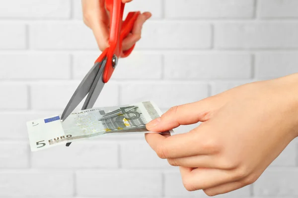 Scissors cutting money — Stock Photo, Image