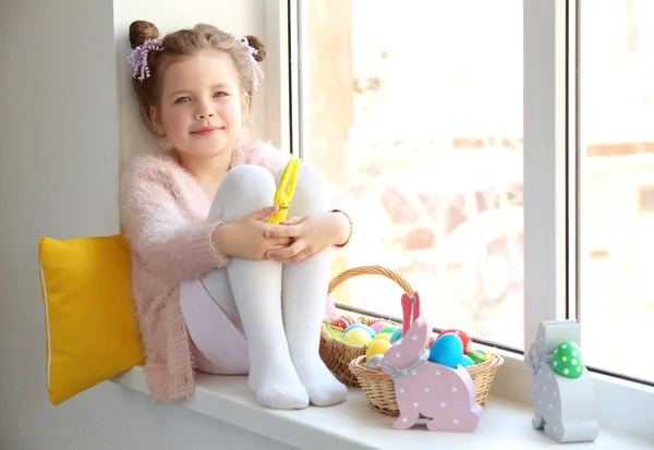 Little girl sitting with Easter eggs — Stock Photo, Image