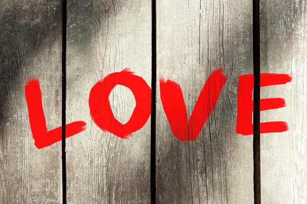 Word "Love" painted on wooden wall — Stock Photo, Image