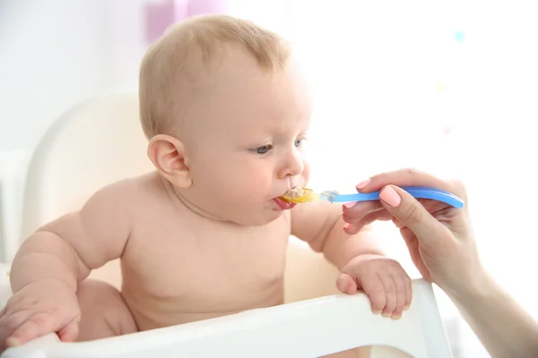 Baby boy eating from a spoon — Stock Photo, Image