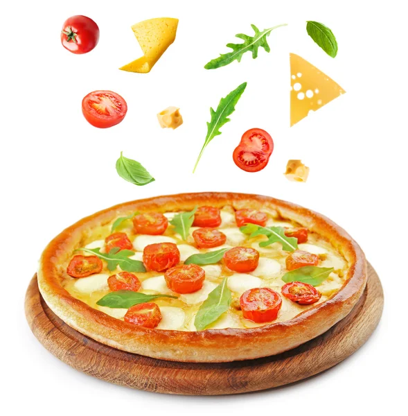 Pizza with falling ingredients — Stock Photo, Image