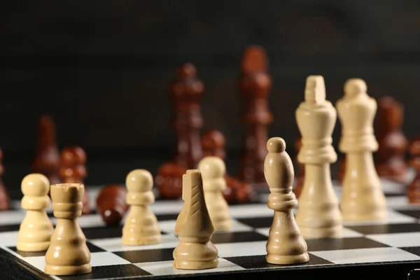 Chess pieces and game board — Stock Photo, Image