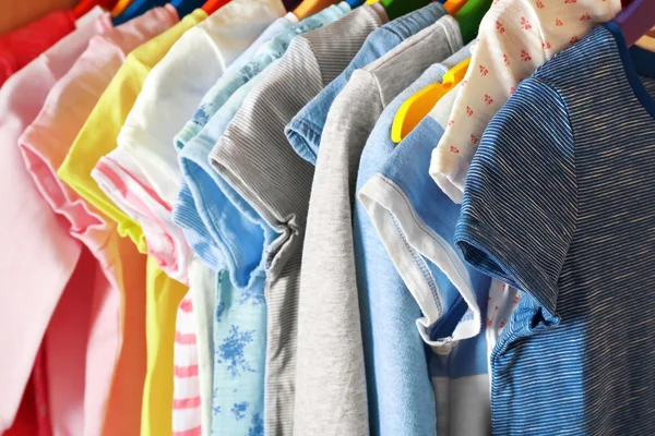 Kid's clothes on hangers — Stock Photo, Image