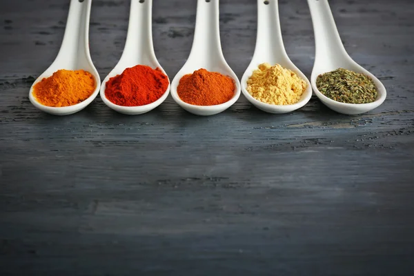 Different kinds of spices in spoons — Stock Photo, Image