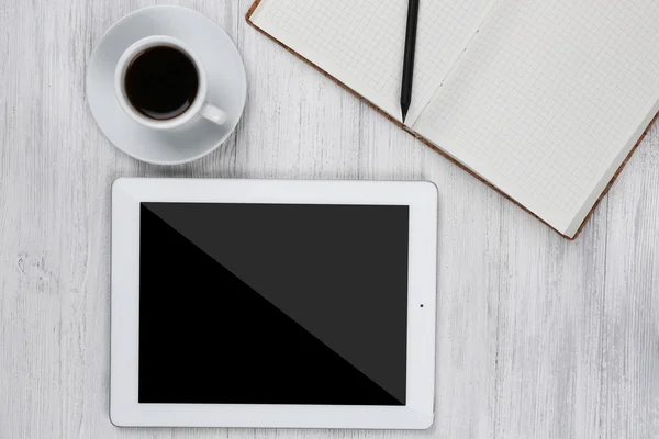 Digital tablet with cup of coffee and notebook — Stock Photo, Image