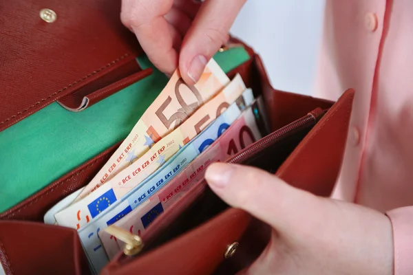 Female hands holding leather purse — Stock Photo, Image