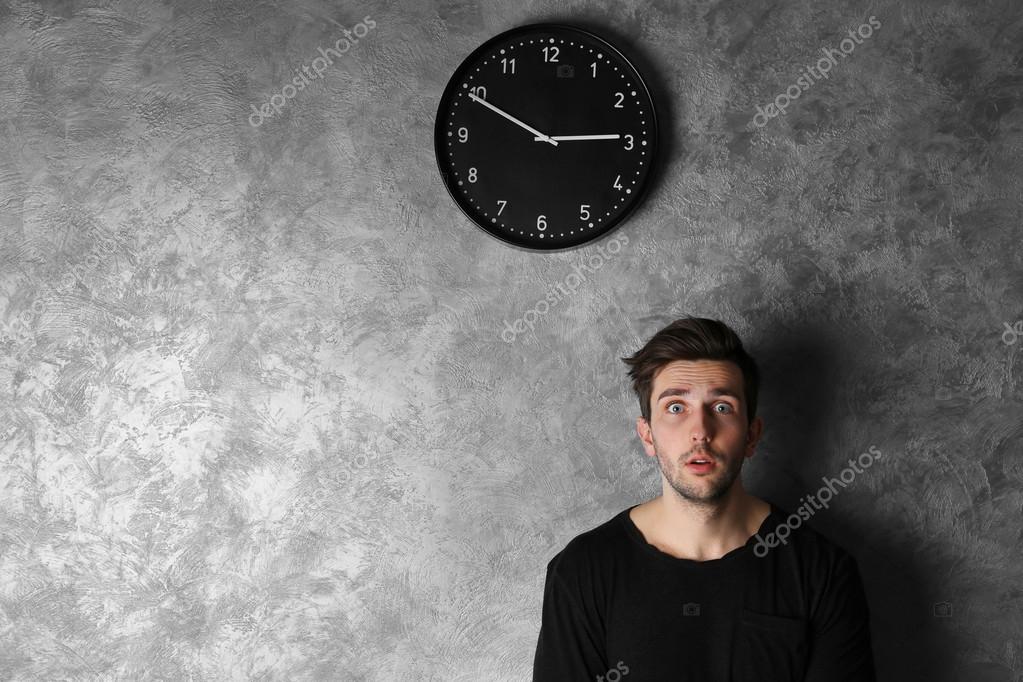 Man standing beside a clock — Stock Photo © belchonock 110367926