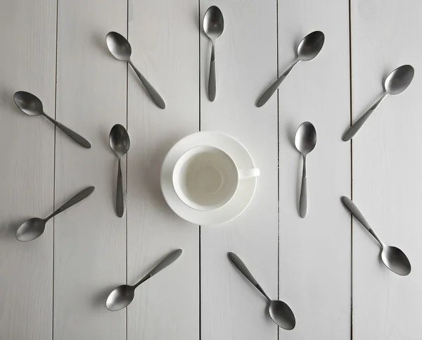 Ceramic cup and silver spoons — Stock Photo, Image