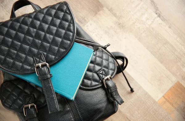 Leather backpack and book — Stock Photo, Image